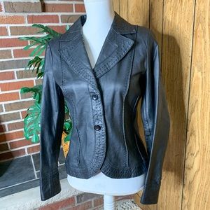 100% leather- black jacket with stitched details. Absolutely beautiful!!!!
